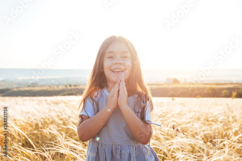 Pretty happy little girl portrait in beautiful landscape.