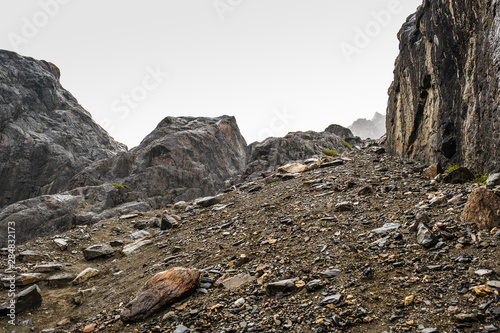 A sloping slope covered with loose stones. Difficult climb to Aktru. Beautiful views of the rounded mountains on a tour of the nature of Altai land. Hiking and mountain climbing in the mountains.