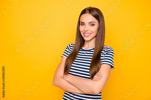 Photo of friendly lady with crossed arms wear striped t-shirt isolated yellow bright background