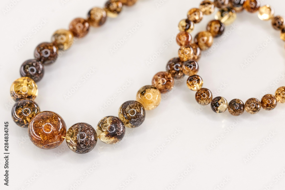 Unique pieces of transparent yellow amber on a white background. Unique pieces of transparent yellow amber on a white background.
