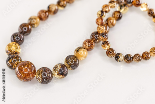Unique pieces of transparent yellow amber on a white background.