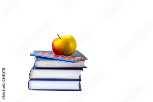 Education or back to school concept. An apple and multi-colored pencils on a stack of book