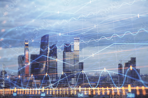 Multi exposure of financial chart on Moscow city downtown background. Concept of stock market analysis