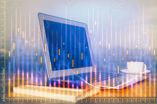 Financial graph colorful drawing and table with computer on background. Multi exposure. Concept of international markets. © peshkova