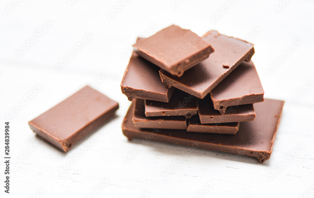 chocolate bar stacked on the white wood background / close up Chocolate pieces candy sweet dessert and snack chocolate bar stacked on the white wood background / close up Chocolate pieces candy sweet dessert and snack