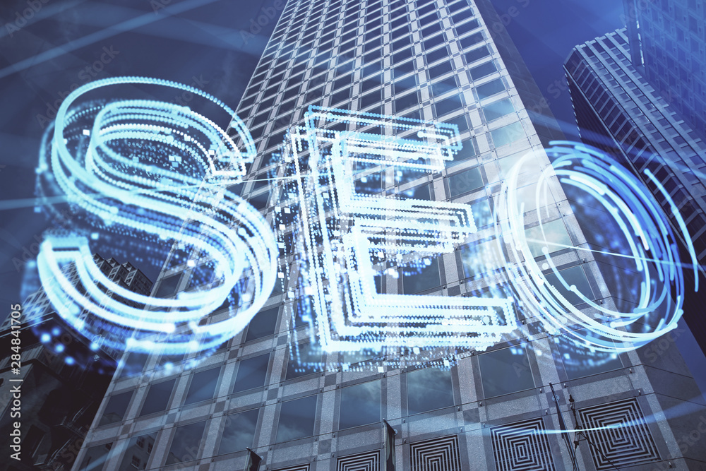 SEO hologram on city view with skyscrapers background double exposure. Search optimization concept. SEO hologram on city view with skyscrapers background double exposure. Search optimization concept.