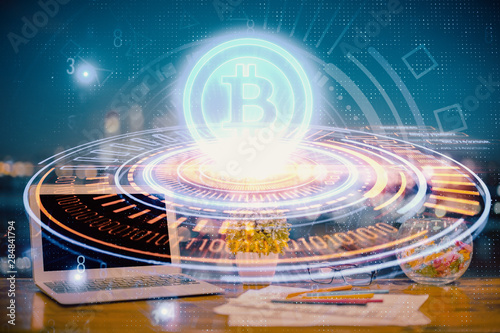 Double exposure of blockchain and crypto economy theme hologram and table with computer background. Concept of bitcoin cryptocurrency. © peshkova