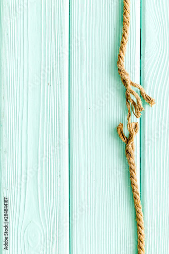 risk concept with rope near to break on mint green wooden background top view space for text