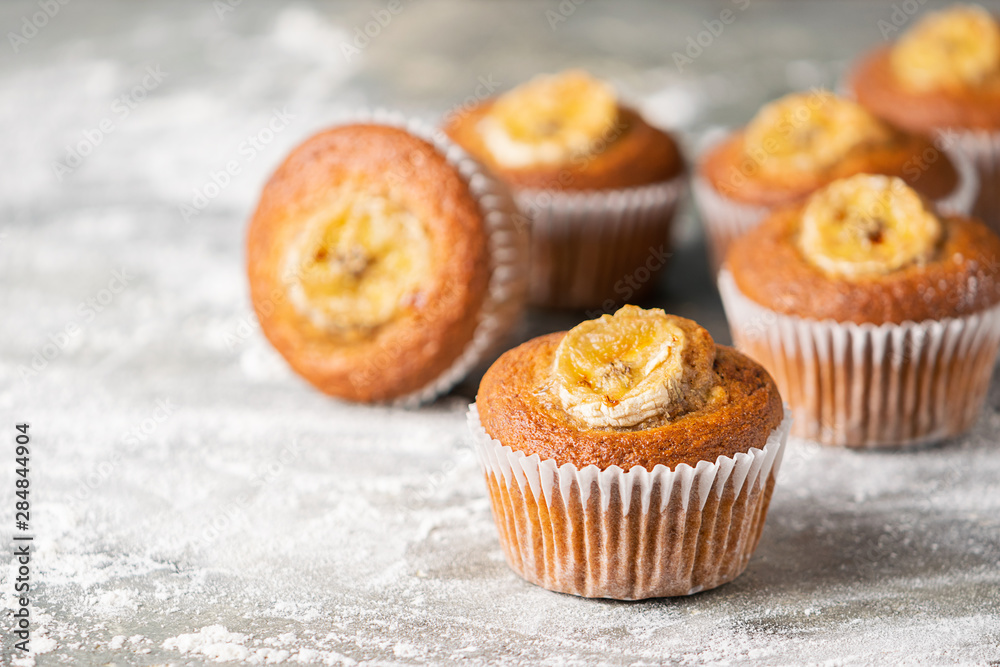 Homemade banana muffins on a gray background. Healthy vegan dessert. Close-up selective focus. Homemade banana muffins on a gray background. Healthy vegan dessert. Close-up selective focus.