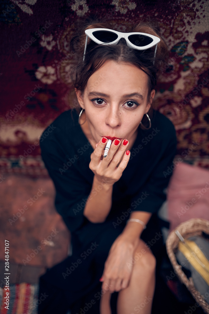 Beautiful girl smokes a cigarette