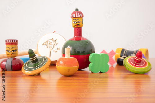 Colourful different types of GI Tagged channapatna toys on table with isolated background.
