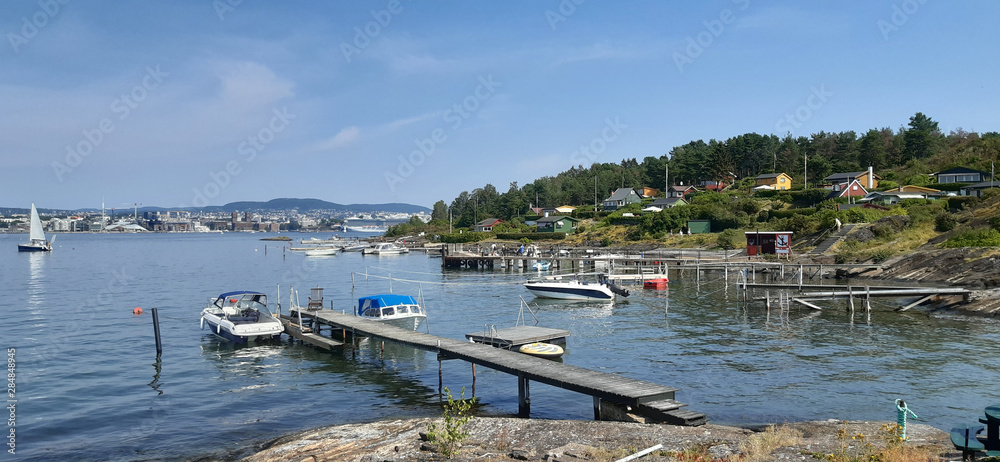 Wooden footbridges in island Lindoya in Oslo Fjord, Norway. Island with summer cottages and marina in summer. 