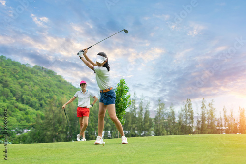 Golf ball on green grass ready to be struck at golf club,close up in golf coures at Thailand