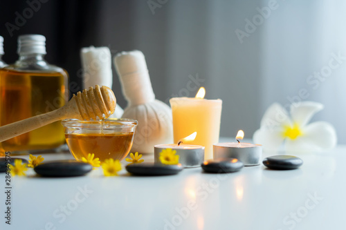 Closeup on honey spa therapy ingredients and salt spa objects on table,wellness and relaxation concept
