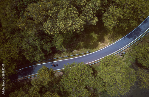 Aerial view of the forest on country road motorcycle rider , Malaysia . © jamesteohart