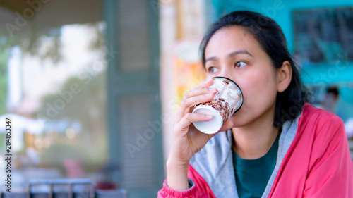 Portrait of Asia women drinking hot coffee in coffee shop © khamkula