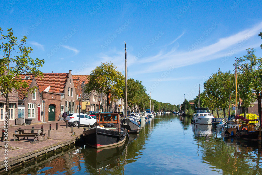 View of Edam Netherlands with canal, boats and traditional architecture