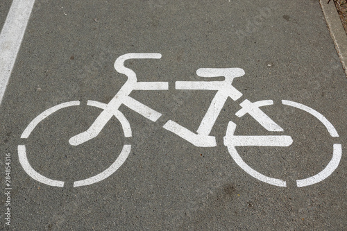 white road sign on the pavement