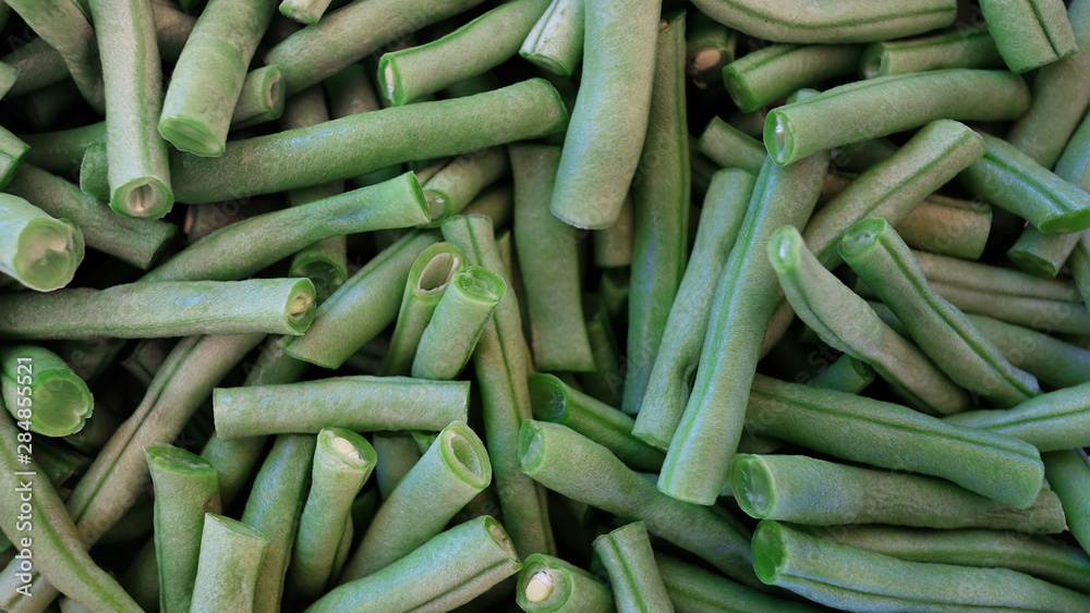 Raw french beans known also as haricot vert, cleaned and cut in short segments, ready to be used in a vegetarian or vegan dish or paired with other dishes, either blanched, fried, sauteed or steamed