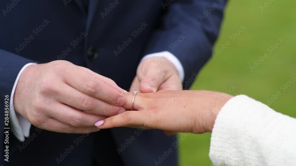 close up, bride and groom wear rings close up, bride and groom wear rings