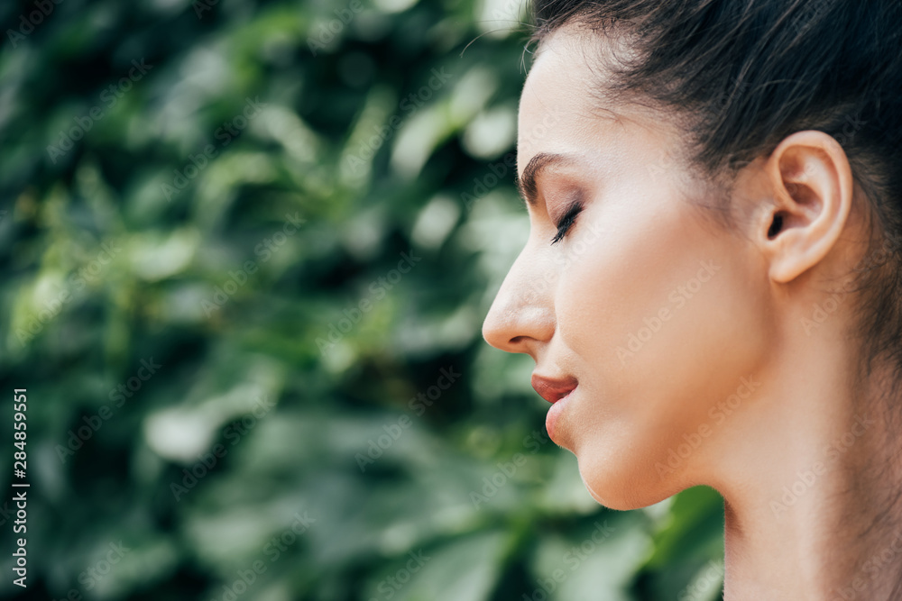 side view of attractive young and naked woman with closed eyes side view of attractive young and naked woman with closed eyes