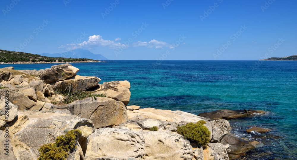 Beautiful seascape with stones and translucent blue water
