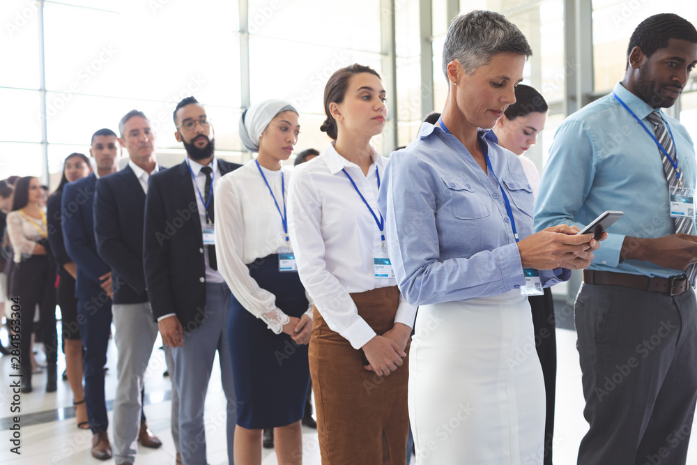 Business people waiting in queue in lobby Business people waiting in queue in lobby