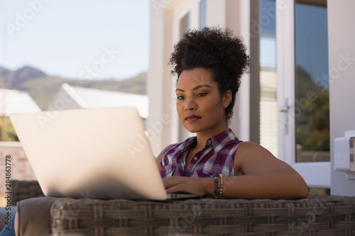 Beautiful woman using laptop on the terrace