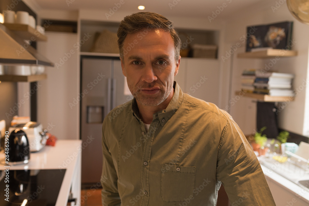 Fototapeta premium Man standing in kitchen at home