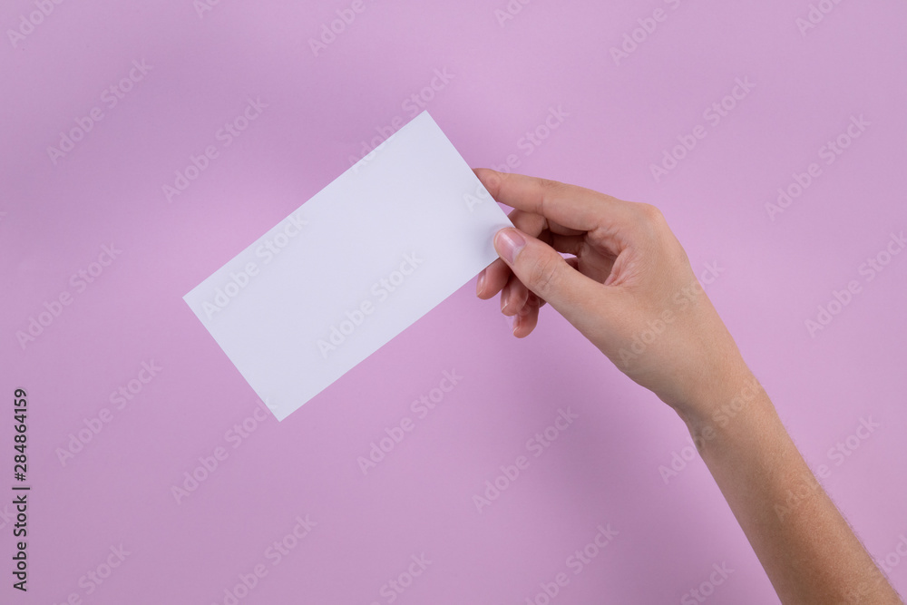Hand holding white post-it note Hand holding white post-it note