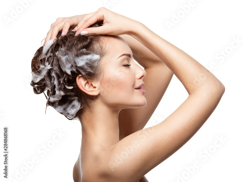 Beautiful woman soaping the brown hair
