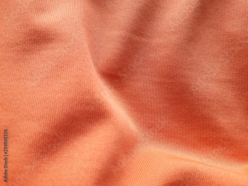 Orange background fabric Swaying like a silk thread when hit by the wind.