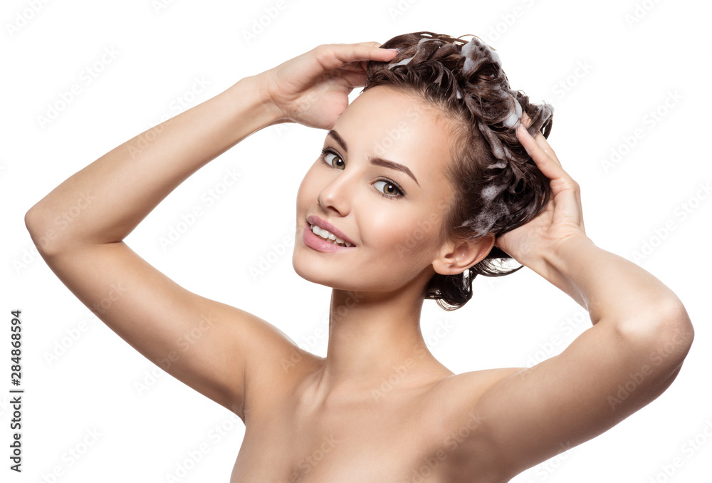 Beautiful smiling woman soaping the hair Beautiful smiling woman soaping the hair