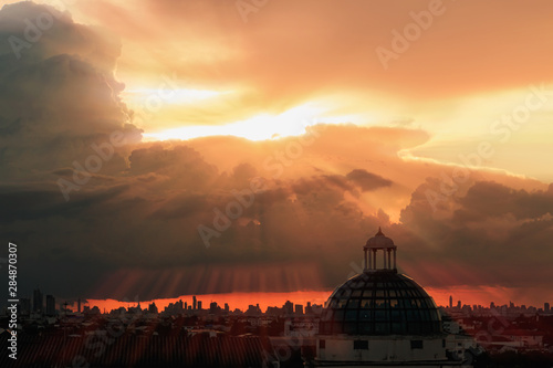 Sky with sunbeams radiating out under colorful during a sunset.line light shining through the clouds