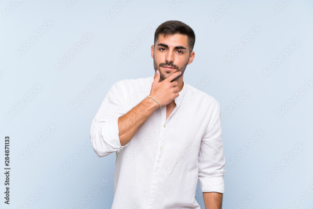 Handsome man with beard over isolated blue background thinking Handsome man with beard over isolated blue background thinking