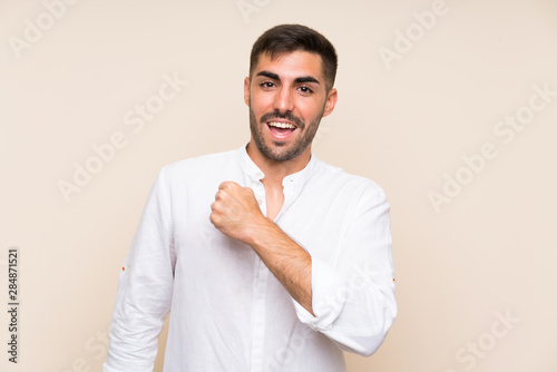 Handsome man with beard over isolated background celebrating a victory