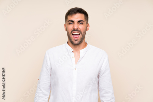 Handsome man with beard over isolated background with surprise facial expression © luismolinero