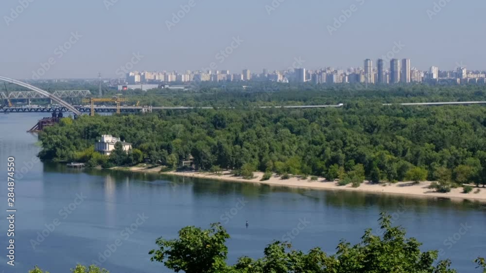 Panoramic video clip views of the embankment of the Dnieper, Kiev, Ukraine 08/19/2019 in the area of Podil, the river station and the new bridge under construction from the right bank Panoramic video clip views of the embankment of the Dnieper, Kiev, Ukraine 08/19/2019 in the area of Podil, the river station and the new bridge under construction from the right bank