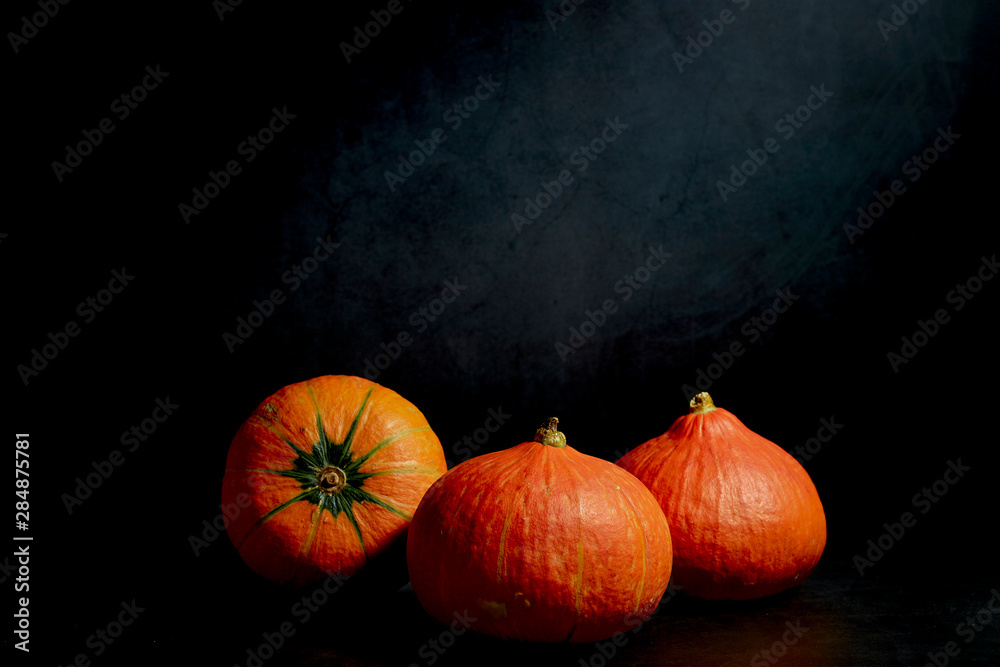 Three Pumpkins in black background