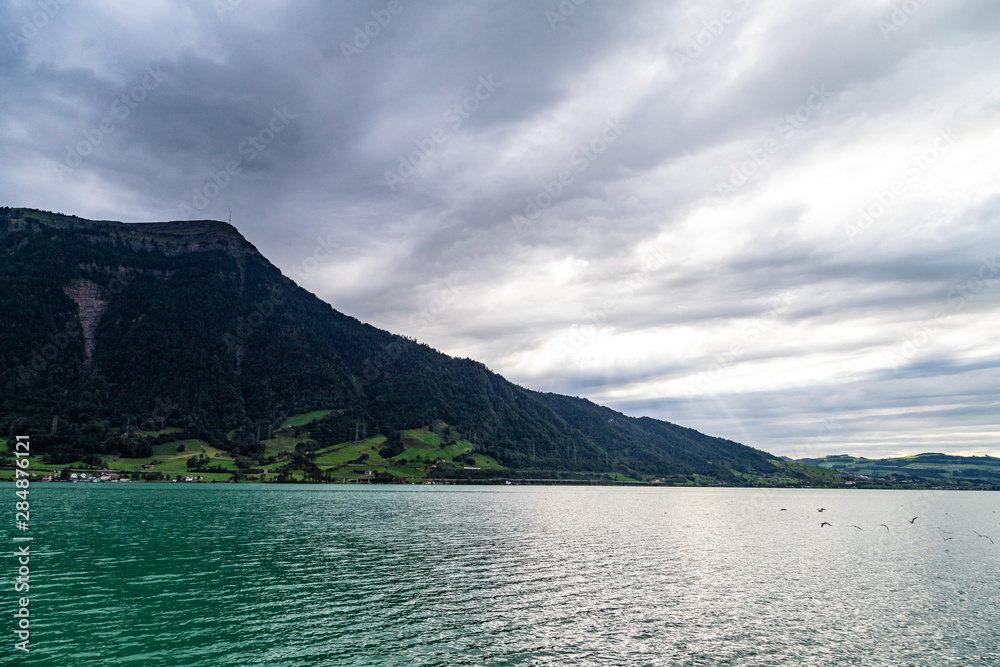 Lake in the mountains. Rigi in background, dark clodus on the sky