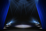Illuminated black stage with curtains