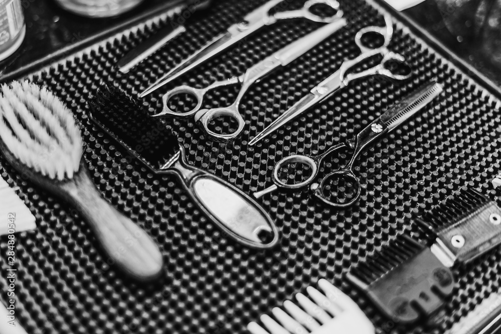 Fototapeta premium Barber tools. Hairdresser's workplace. A great plan. Black and white photo.