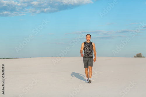 Portrait fit man in white sand desert