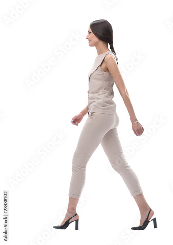 side view. confident young woman stepping forward