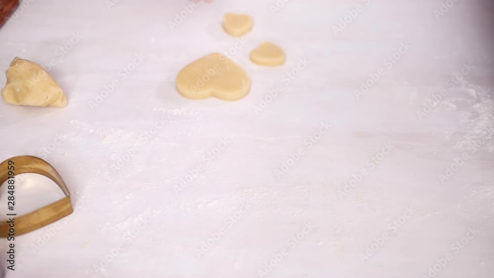 Step by step. Cutting out shapes from sugar cookie dough with cookie cutters.