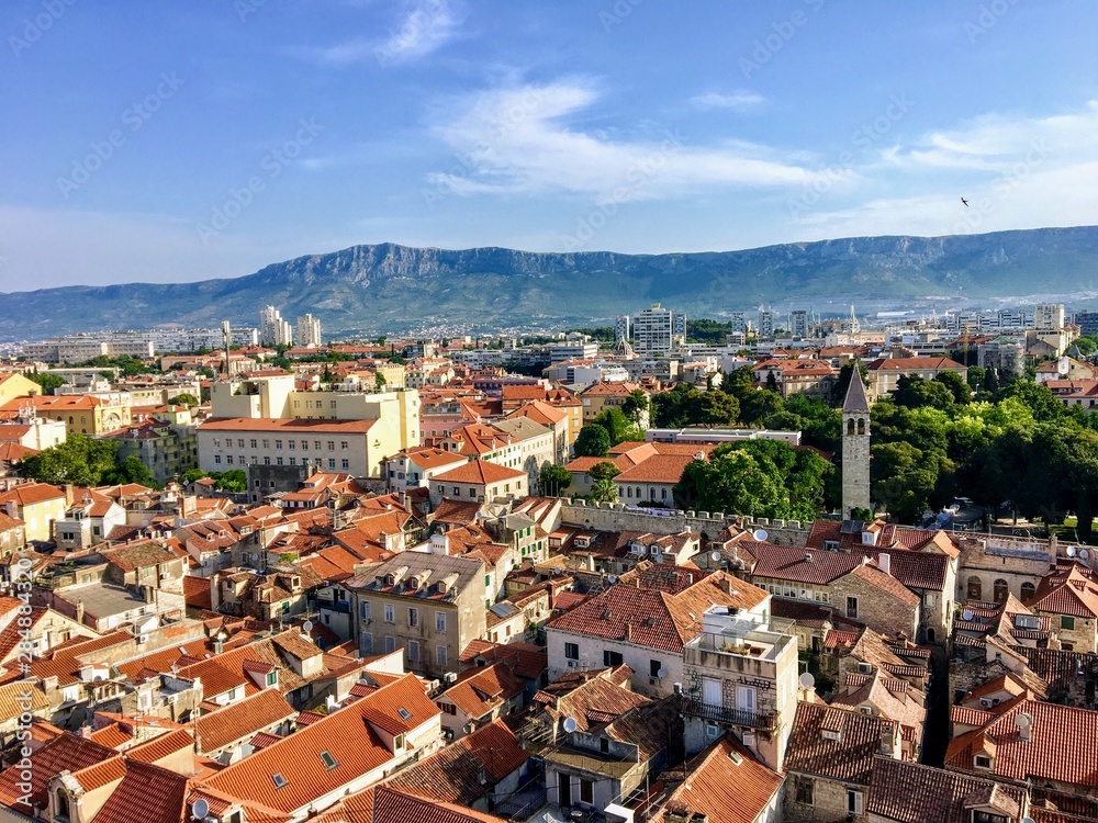 A wide view of the beautiful city of Split, Croatia from high above atop the clock tower in the old town.  In the background are the mosor mountain ranges.
