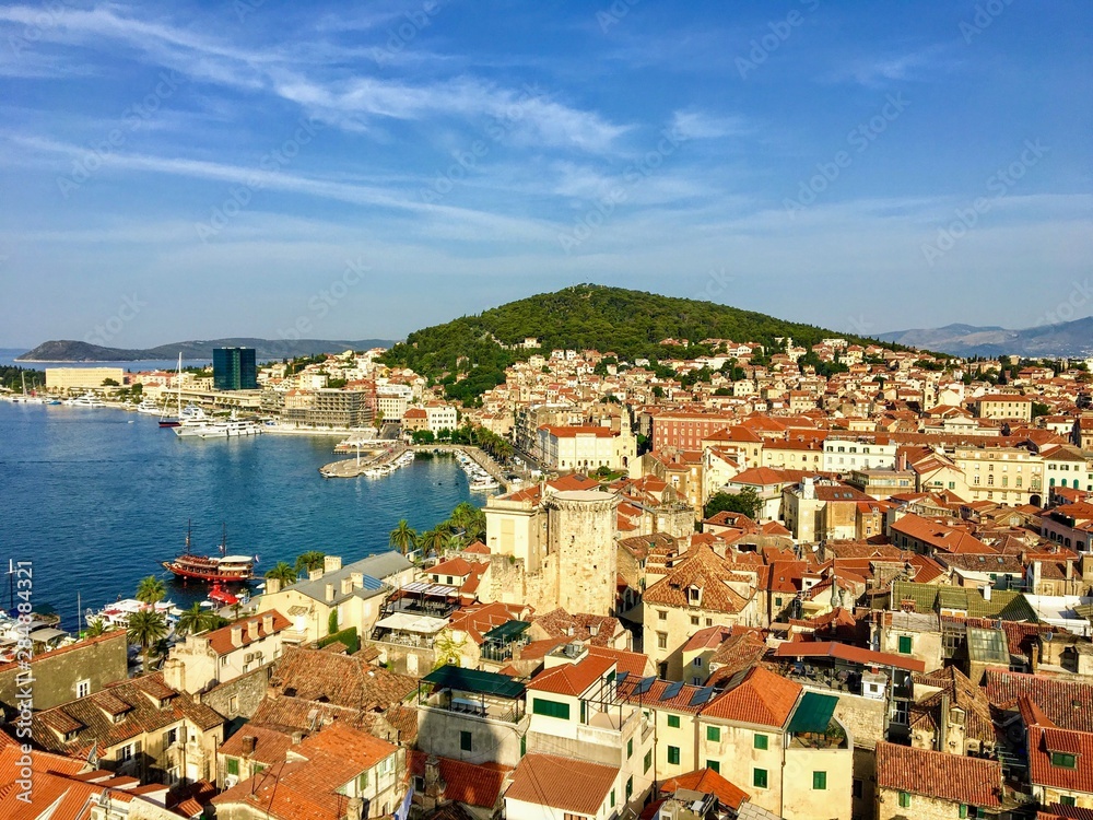 A wide view of the beautiful city of Split, Croatia from high above atop the clock tower in the old town.  In the background is the adriatic sea and the famous Marjan Hill.