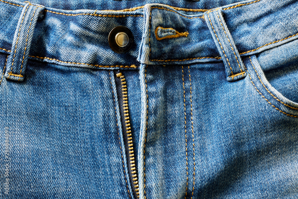 Front of blue jeans with open zipper. Front of blue jeans with open zipper.