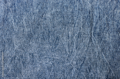 Fragment of the blue denim. Jeans background or texture.