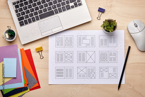 Editorial designer desk with publication layout photo